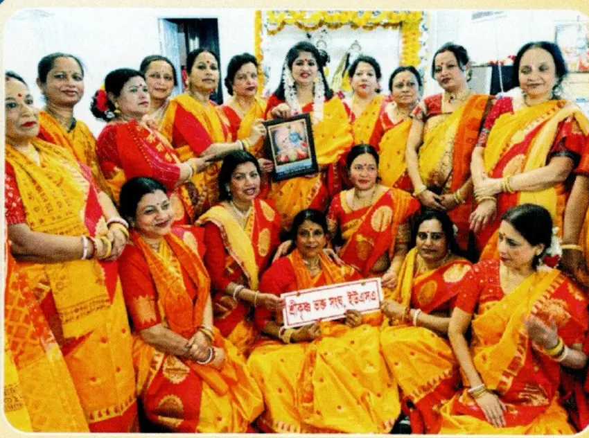 Women in traditional Bengali sarees at a community celebration