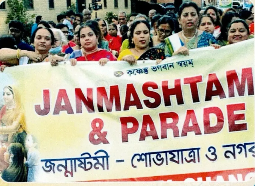 Devotees carrying a Janmashtami parade banner
